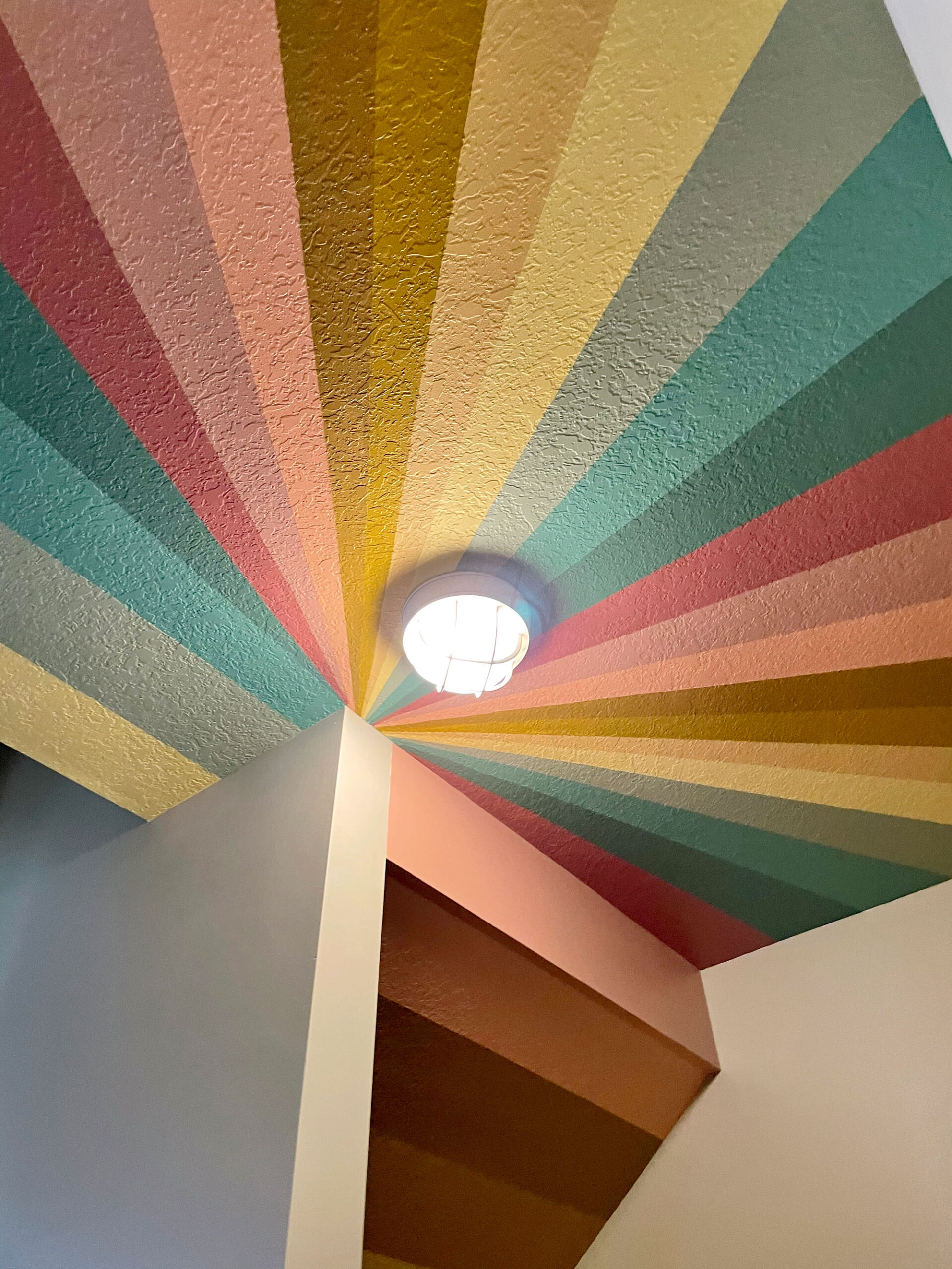 A colorful rainbow under the stairs secret clubhouse mural! :)