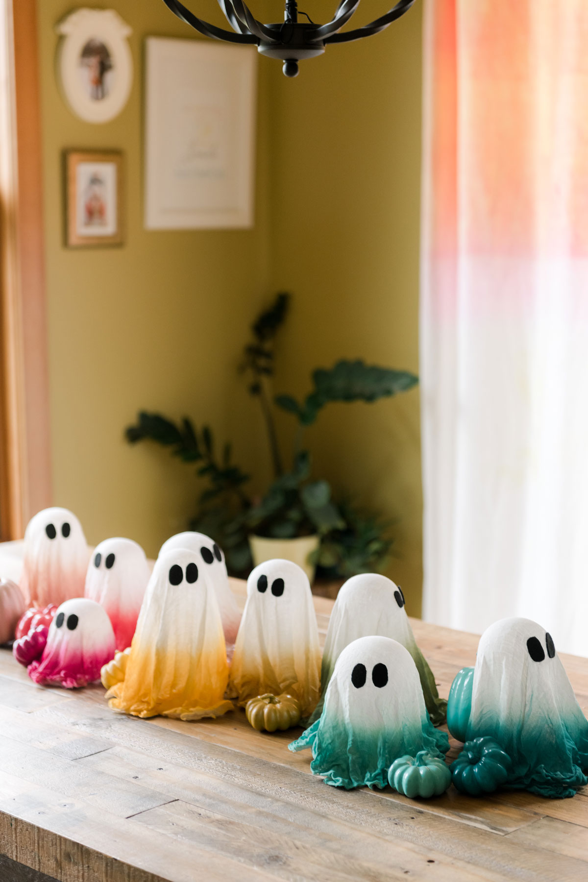 Colorful cheesecloth ghosts, rainbow halloween decor ideas, rainbow halloween decor, colorful rainbow decor for halloween, colorful halloween ghosts, rainbow ghosts for halloween