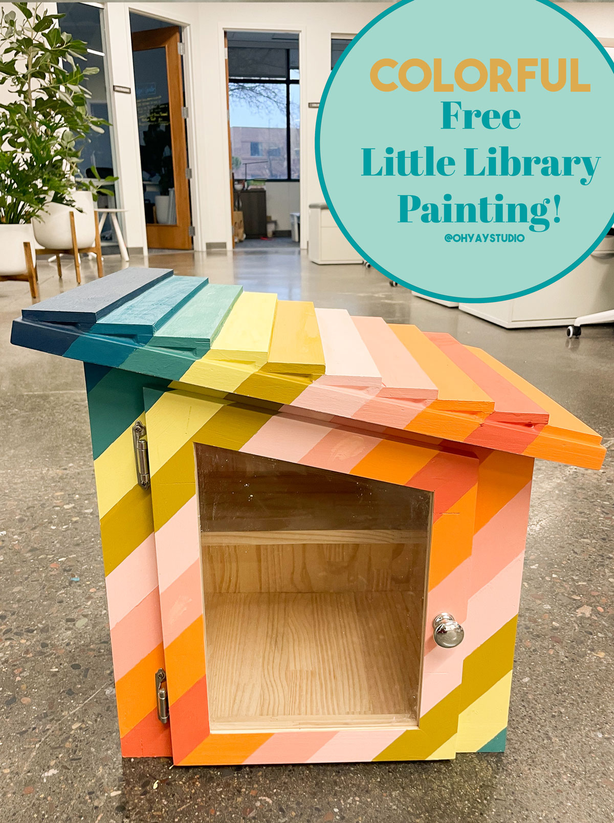 A stripy colorfully painted free little library oh yay studio